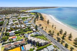 an aerial view of a beach with houses and a road at Esplanade Absolute Beach Frontage 12-20 in Torquay