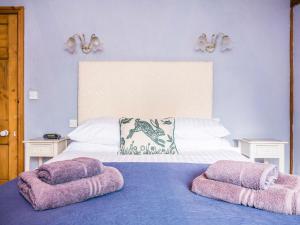 a bedroom with a bed with two pillows on it at Anvil Cottage in Biscathorpe