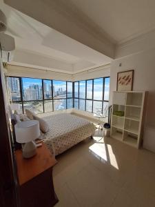 a bedroom with a bed with a view of the ocean at Apartamento Luxury frente al mar in Cartagena de Indias