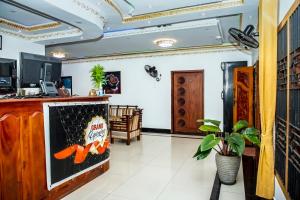 a lobby of a restaurant with a counter with a sign at Golden Star Guest House in Jaffna