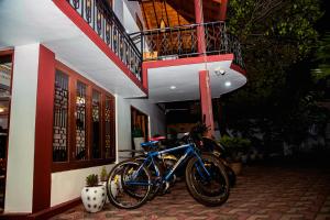 a blue bike parked on the side of a building at Golden Star Guest House in Jaffna