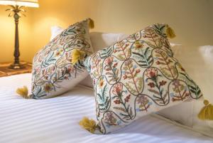 a bed with two pillows on top of it at Sassafras village stay - historic home sleeps 4 in Sassafras