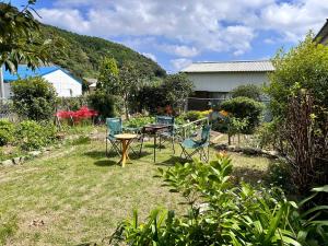 a garden with a table and chairs in the grass at Guest House Island in Wakamatsu