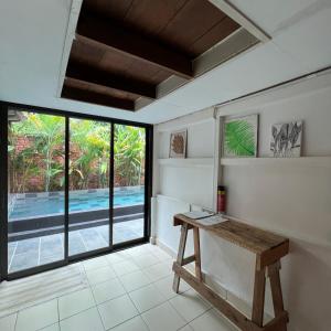 Zimmer mit einem Tisch und Poolblick in der Unterkunft Kutum's Wooden House - Private Pool, Breakfast & Cafe in Huma