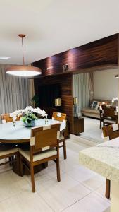 a dining room and living room with a table and chairs at flat kariris de luxe in Juazeiro do Norte