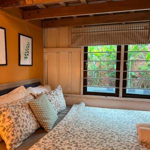 a bedroom with a bed and a window at Kutum's Wooden House - Private Pool, Breakfast & Cafe in Huma