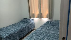 two beds sitting next to each other in a bedroom at Apartamento no NDM Bessa in João Pessoa