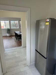 a kitchen with a refrigerator and a dining room at Away on Blende Studio Loft in Broken Hill