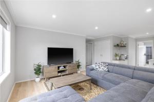 a living room with a blue couch and a tv at Sea you soon in Cowes