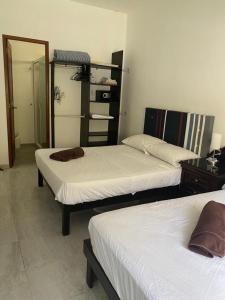 a room with two beds and a mirror at Private Room Puerto Morelos in Puerto Morelos +19 photos