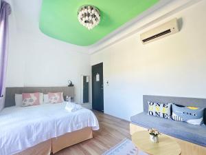 南灣的住宿－南灣陽光皮小妞 Pii hostel，一间卧室设有一张床和绿色的天花板