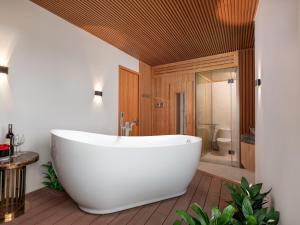 a large white bath tub in a bathroom at MoonLight Tay Ho in Hanoi