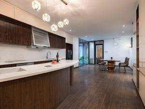 an open kitchen and dining room with a table at MoonLight Tay Ho in Hanoi