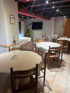 a room with two tables and chairs and a christmas tree at Sur la Route du Vin in Rorschwihr
