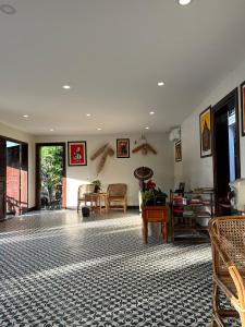 a lobby with a room with tables and chairs at Villa Namkhan Heritage in Luang Prabang