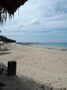 a view of a beach with people in the water at Poohry Seaview in Ko Lanta