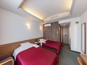 Säng eller sängar i ett rum på Okinawa Hotel