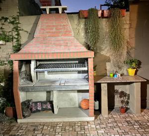 a barbecue grill sitting on a patio at Monoambiente Noah in Ezeiza