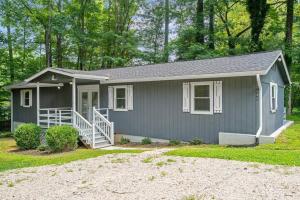 a small gray house with a porch at Spacious home- near Airport, Crabtree Mall & Food in Raleigh