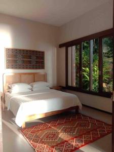 Säng eller sängar i ett rum på Terrace Villa - Pelabuhan Ratu