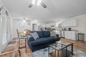 a living room with a blue couch and a kitchen at Spacious home- near Airport, Crabtree Mall & Food in Raleigh