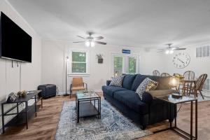 a living room with a couch and a tv at Spacious home- near Airport, Crabtree Mall & Food in Raleigh