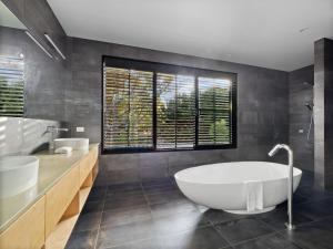 a bathroom with a large tub and two sinks at SpaceNature in Margaret River Town +29 photos