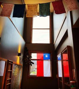 una habitación con una ventana con una bandera. en Esquina Huella Patagónica, en Coyhaique