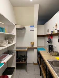 a large kitchen with white cabinets and a sink at Esquina Huella Patagónica in Coihaique