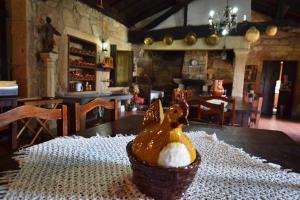 a wooden chicken sitting on a table in a room at Casa de Sta Comba in Barcelos +52 photos