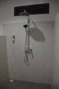 a shower in the corner of a bathroom at AMIGOS BUNGALOWS GILI MENO in Gili Meno