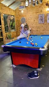 two people playing pool in a pool table at Sapa the chill garden &villas in Sa Pa