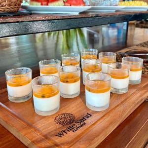 a group of glasses of food on a wooden tray at Koh Mak White Sand Beach in Ko Mak