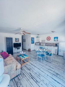 a living room with a couch and a table at Playa Esmeralda One Bedroom Cottages in Bradenton Beach