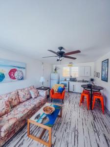 a living room with a couch and a table at Playa Esmeralda One Bedroom Cottages in Bradenton Beach