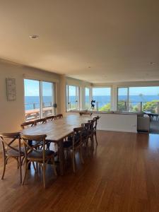 a large room with a wooden table and chairs at 106 Ocean Parade Dalmeny in Dalmeny