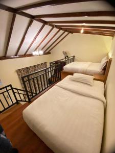 a room with two beds in a room at BERYL HOMESTAY in Tarutung