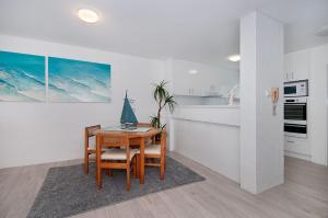 a kitchen with a table with a sailboat on it at Quarterdeck 4 - Lennox Head in Lennox Head