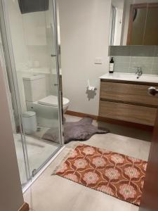 a bathroom with a shower and a rug on the floor at Amaroo with a view set on a 50 Acre Hobby Farm in Collinsvale