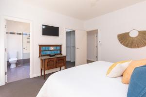 a bedroom with a bed and a bathroom with a toilet at Yarlu-Ityangka in Sellicks Beach
