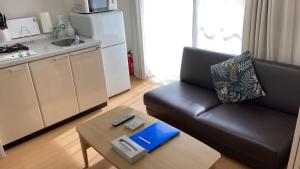 a living room with a couch and a coffee table at カナン中央町A館 in Kagoshima