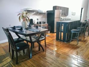 a dining room table with chairs and a kitchen at Gorgeous Downtown Detroit Loft - Fully Equipped in Detroit