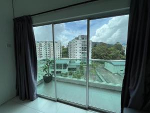 a large window with a view of a city at DreamStay,Tanah Rata,TheQuintet in Tanah Rata