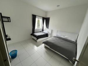 a bedroom with two beds and a window at DreamStay,Tanah Rata,TheQuintet in Tanah Rata