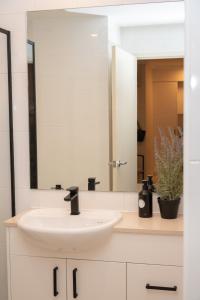 a bathroom with a sink and a mirror at PRIME SPOT: Modern Studio+Balcony Darling Harbour in Sydney