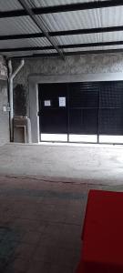 an empty train station with a window and a red rug at Alquiler de casa por día. in Santiago del Estero