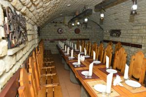 a long table in a room with wooden chairs at Pensiunea Butoias Glodeni in Glodeni