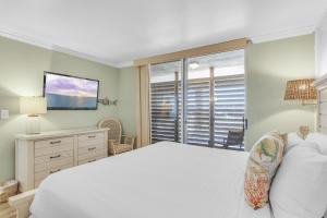 a bedroom with a large white bed and a window at Magnolia House 507 At Destin Pointe Resort in Destin +35 photos