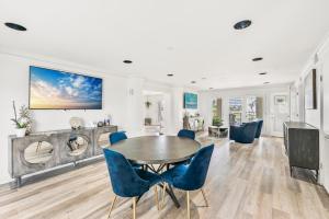 a dining room with a table and blue chairs at Magnolia House 507 At Destin Pointe Resort in Destin