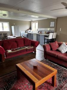 a living room with two couches and a coffee table at Rainbow Mountain cottage in Rotorua
